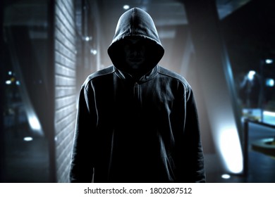 Thief in black clothes on room background