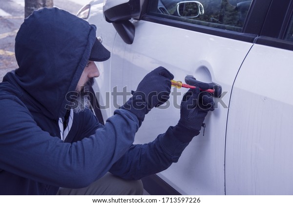 thief breaking the car
lock