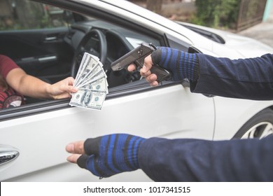 Thief With Gun On Motorcycle Stealing Money From Woman In The Car (theft Concept)
