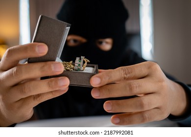 Thief Holding Jewelry Indoor. Robbery Concept.