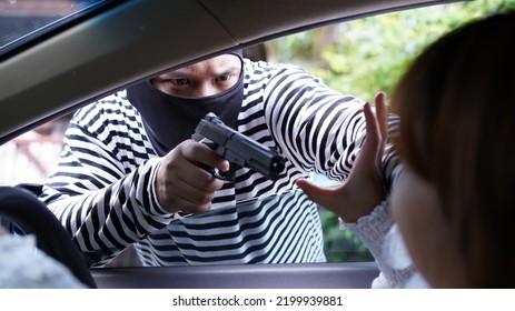 Thief, Male In Long Sleeve White And Black Striped With Short Gun, Rob Woman In Car. Robber Threaten Asian Female Driver In Sedan Car In Day. Car Key Stolen.