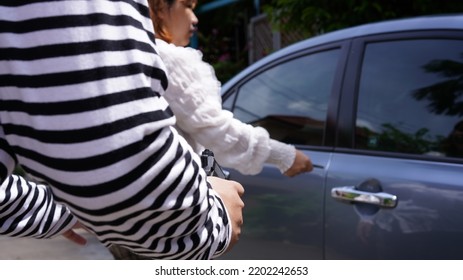 Thief, Male In Long Sleeve White And Black Striped With Short Gun, Rob Woman In Car. Robber Threaten Asian Female Driver In Sedan Car In Day. Car Key Stolen.