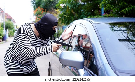 Thief, Male In Long Sleeve White And Black Striped With Short Gun, Rob Woman In Car. Robber Threaten Asian Female Driver In Sedan Car In Day. Car Key Stolen.