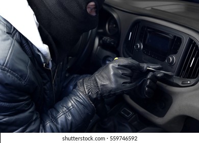 Thief In Mask Trying To Steal Car Radio With Screwdriver