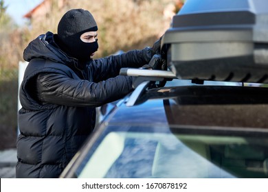 Thief Opens Roof Box Or Roof Rack On A Car For Theft