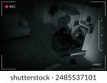 Thief robbing house, view through surveillance camera