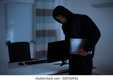 Thief Stealing Computer And Laptop From Office