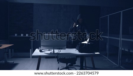 Thief Stealing Computer From Office At Night