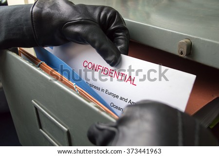 thief stealing confidential files in an office