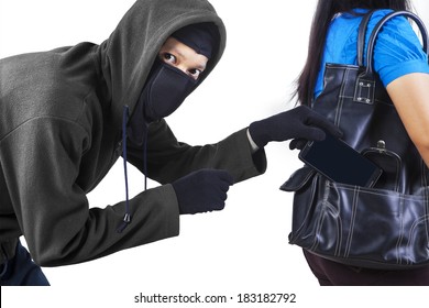 Thief Stealing A Mobile Phone From Handbag Of A Woman Isolated On White