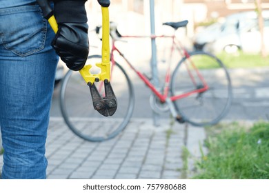 Thief Stealing A Parked Bike In The City Street