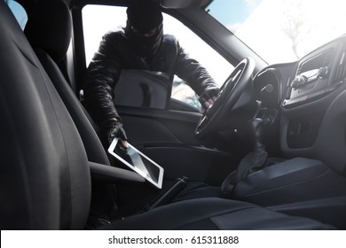 Thief Stealing Tablet From Car