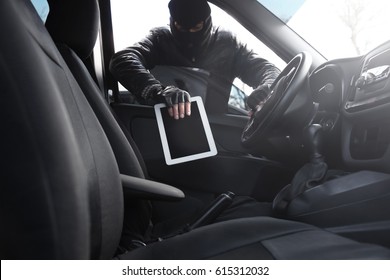 Thief Stealing Tablet From Car