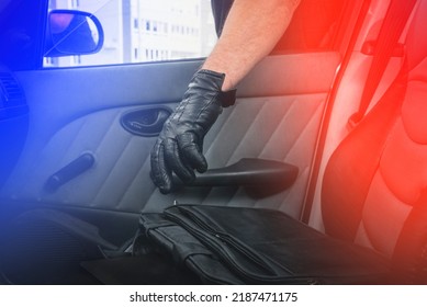 Thief Steals A Laptop Bag From The Passenger Seat From An Open Car Window. View From Inside The Automobile Interior. Concept Of Robbery.