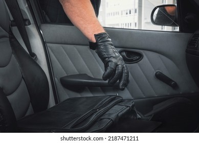 Thief Steals A Laptop Bag From The Passenger Seat From An Open Car Window. View From Inside The Automobile Interior. Concept Of Robbery.