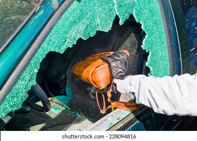 A Thief Stole A Purse From A Car Through A Broken Side Window.