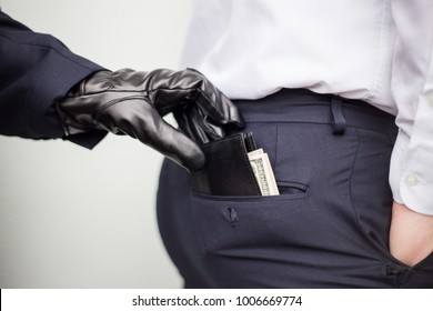 A thief takes a wallet with a cash from a pocket of a man in a suit, a businessman, a crime, a pocket