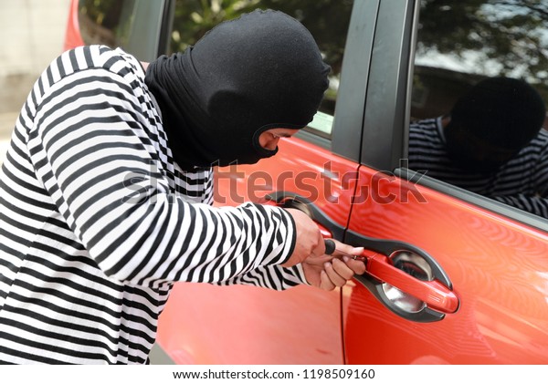 thief try to break into car with screwdriver\
(theft concept)\
