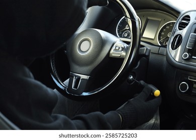 Thief trying to start ignition switch with screwdriver, closeup. Car hijacking