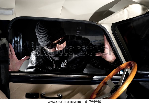 Thief trying to steal a\
car