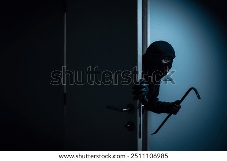 Thief in uniform black jacket various action housebreak. The Robber terrorism criminal escapes with balaclava and crowbar entering a house for stealing Housebreak at night