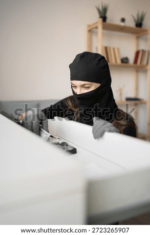 Thief in uniform black jacket various pose on isolated background. The Robber terrorism criminal escapes with balaclava and crowbar entering a house for stealing Housebreak