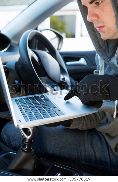 Thief\
Using Laptop To Hack Into Car Security\
Software