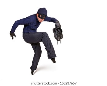 thief walking on tiptoe. Burglar with a mask on his face walking quietly isolated on a white background. Robber in dark clothes careful walks on tiptoe. Thief is trying move silently tip-toe.