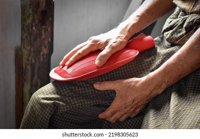 Thigh Pain In Asian Senior Male Patient. Concept Of Muscle Sprain, Sciatica Or Sciatic Nerve Pain. Therapy By Rubber Hot Water Bag.