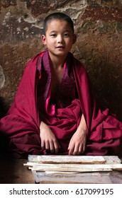 Thimphu, Bhutan - JUN 20, 2007: Novice Monk Learning And Writing In Temple