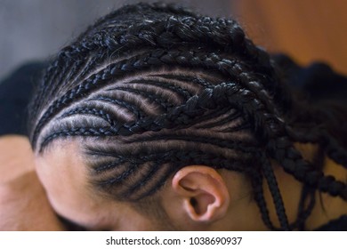 thin braids braided on the head of a man, photo close-up for a background - Powered by Shutterstock