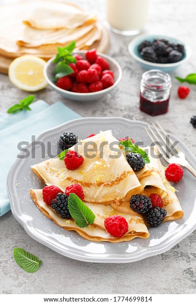 Thin crepes with fresh berries and lemon\
zest. Pancakes with raspberry and\
blackberry.