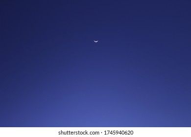 Thin Crescent Moon And Blue Sky