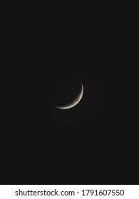 A Thin Crescent Moon In A Cloudless Sky