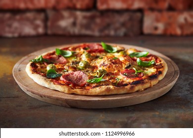 Thin crust pizza with ham, cheese and olive.  Freshly baked pizza (from wood-fired oven).