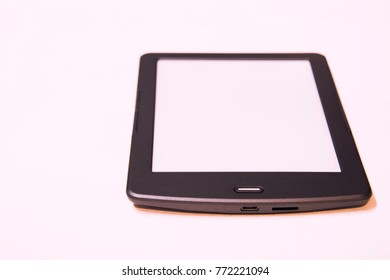 Thin e-book with touch screen on white background.Replacing paper books. Convenience and comfort of reading. Isolated.