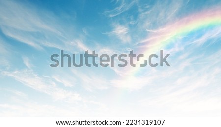 Thin elegant clouds and incredible rainbow in the blue sky. Natural sky background. 3D stretch ceiling decoration image.