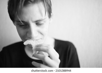 Thin And Emaciated Young Man Eating Bread