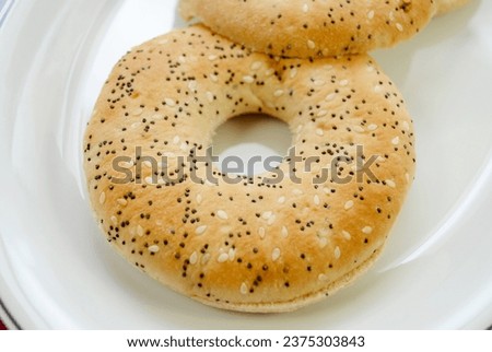 Thin Everything Bagels Isolated Over a White Plate	