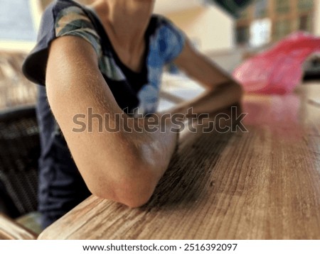 thin girl sits at the table and does not eat. is thinking about what to choose as a vegetarian dish on the restaurant menu. she is on a diet and is bulimic