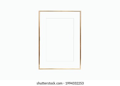 Thin Gold Frame With Mat On A White Wall. Mockup For Your Design.