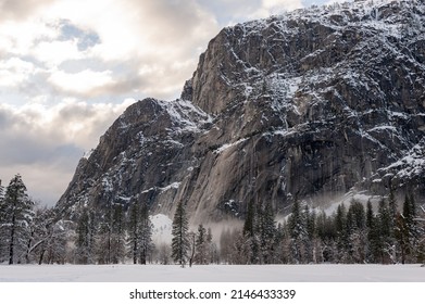 A thin layer of mis has developed in Yosemite valley floor on a snowy winter afternoon, just before sunset.