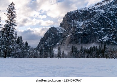 A thin layer of mis has developed in Yosemite valley floor on a snowy winter afternoon, just before sunset.