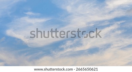 Thin Layered Clouds under a Soft Blue Evening Sky.