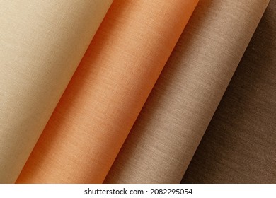 Thin linen twisted in waves in warm flesh shades, screensaver, beige background. High quality photo