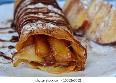 Thin Pancake (crepe) With Apple, Cinnamon And Caramel Filling, Stuffed Roll Closeup