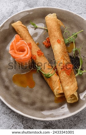 Thin pancakes, blini with red caviar and salmon. Traditional Russian Crepes Blini. Maslenitsa traditional Russian festival meal. Russian food.