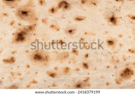 Thin pita bread texture background. Armenian pita bread unleavened flat bread. Top view. Freshly baked homemade oriental bread. Lavash as a textured background.