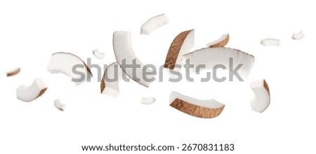 Thin semicircular slices of coconut fly and levitate in space. Isolated on white