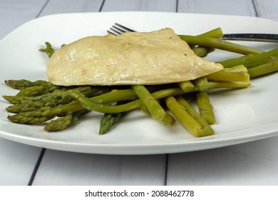 Thin Slice Chicken Breast On Top Of Asparagus